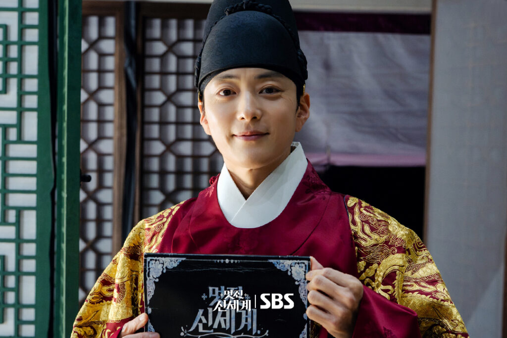 Jang Seung-jo em trajes reais de Joseon segura o roteiro do episódio final de My Royal Nemesis