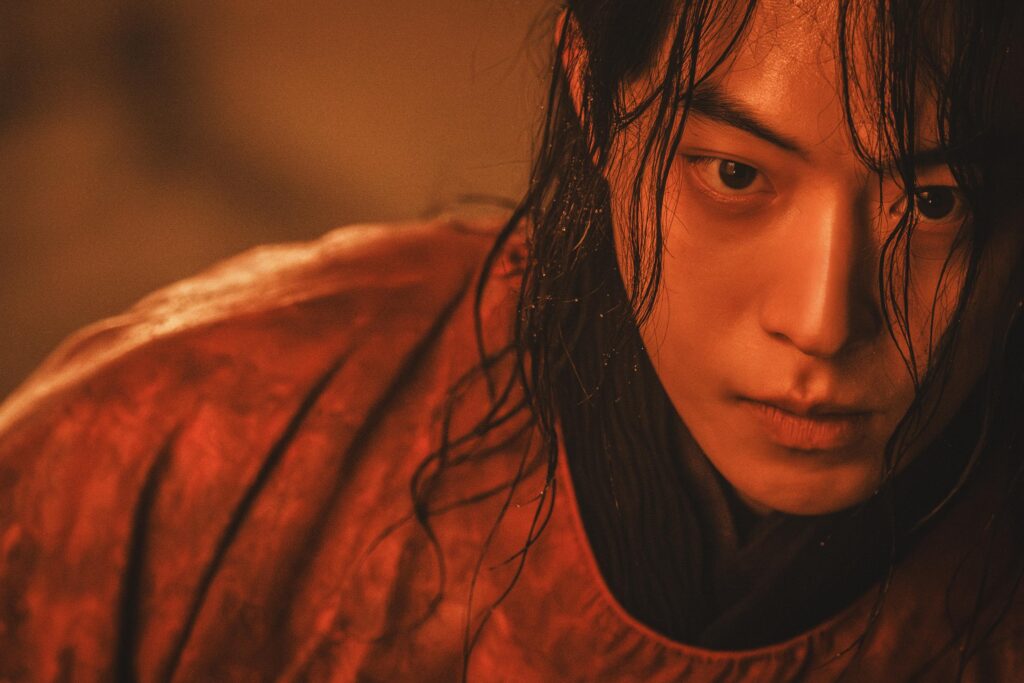 Nam Joo-hyuk como Gu-cheon envolto em aura vermelha no mundo dos fantasmas em A Leste do Palácio